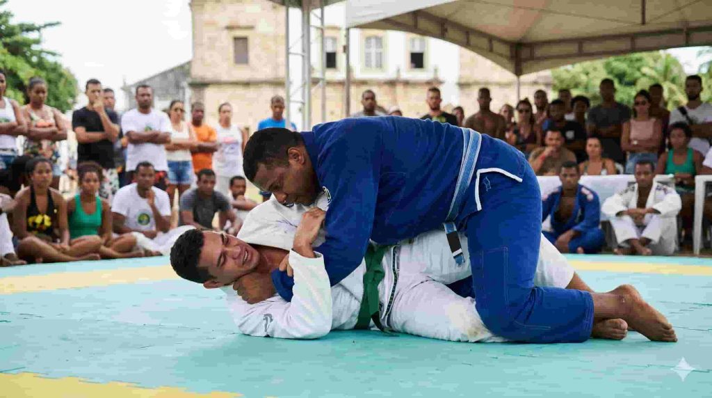 Passagem de guarda no Jiu-Jitsu: o que é, como vale e por que é tão difícil 1 passagem de guarda — atleta de jiu-jitsu supera as pernas do adversário em competição